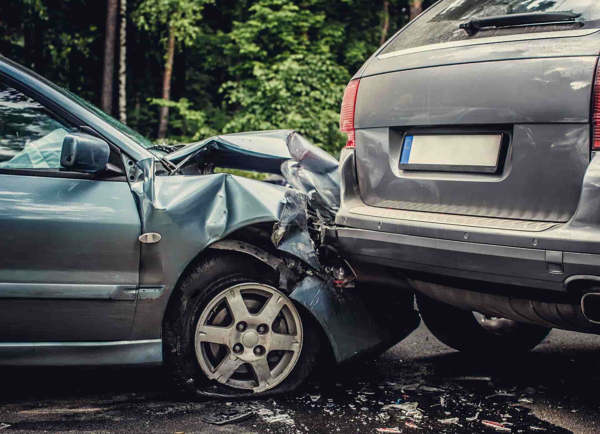 A rear-end collision between two cars on a roadway, illustrating the types of auto accidents that can lead to neck, back, and soft-tissue injuries. Our Indian Trail clinic provides comprehensive evaluation and treatment for individuals involved in car accidents.