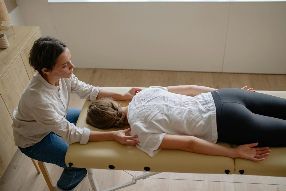 Female runner receiving chiropractic treatment on therapy table