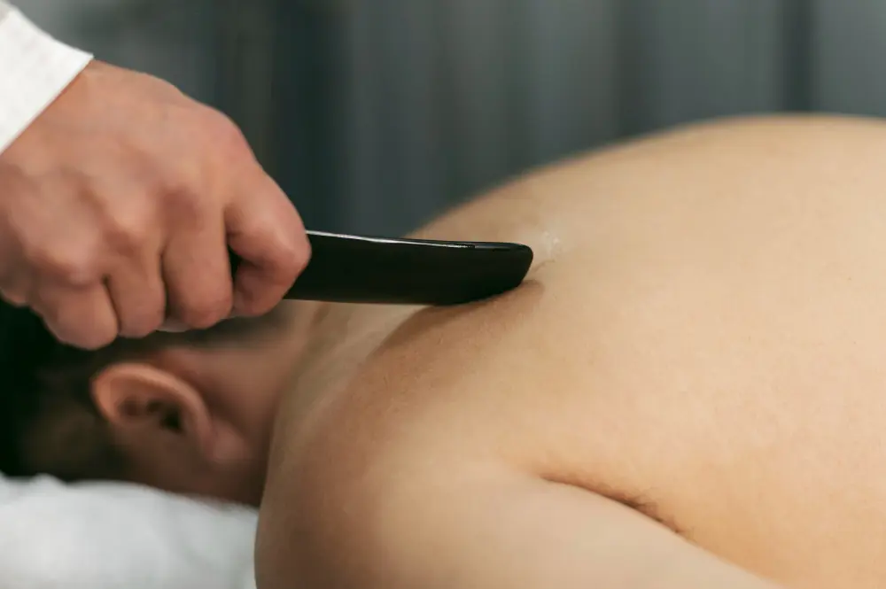 Chiropractor performing Graston Technique soft tissue therapy
