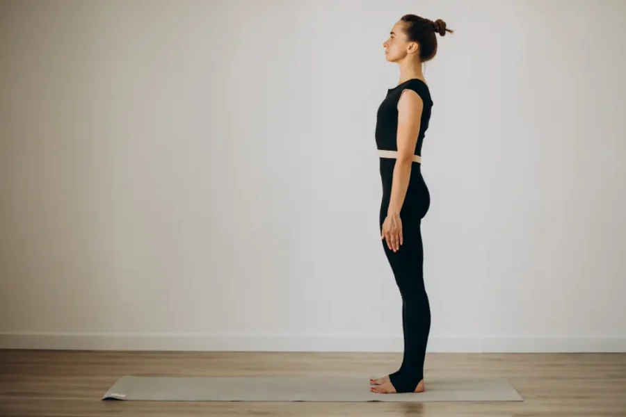 Office worker with poor posture while working on laptop