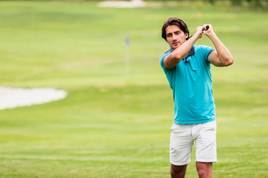Chiropractor treating golfer to improve swing mobility and reduce back and shoulder strain