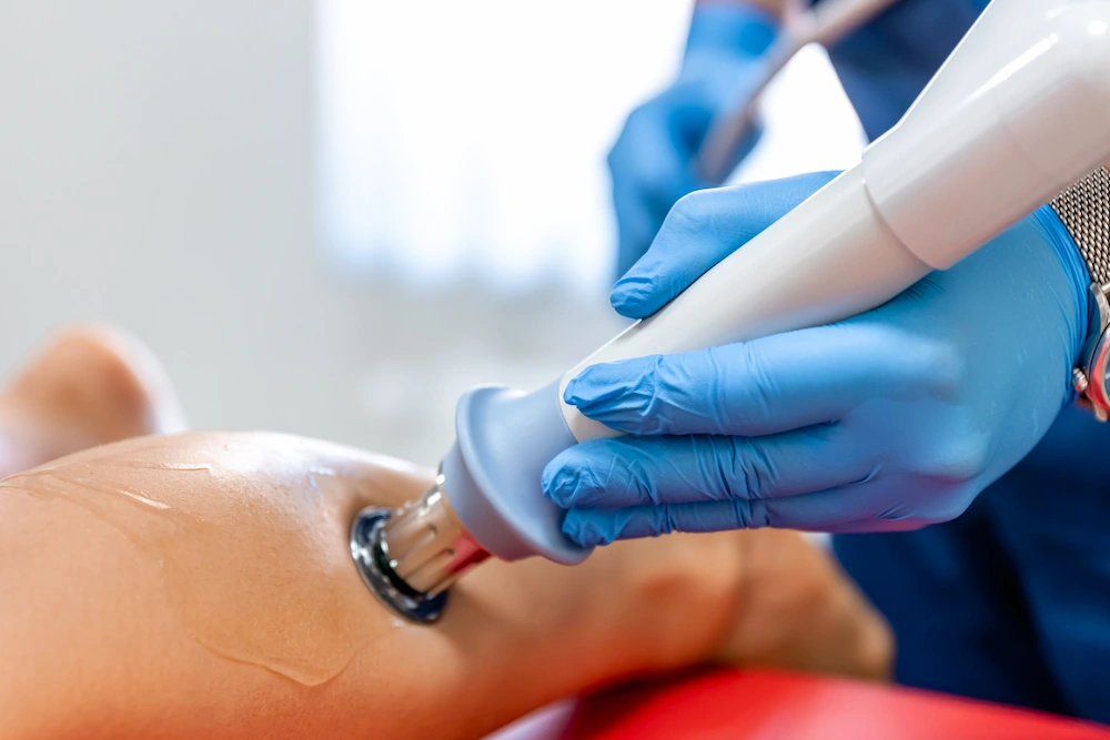 Person receiving laser therapy treatment for foot neuropathy symptoms