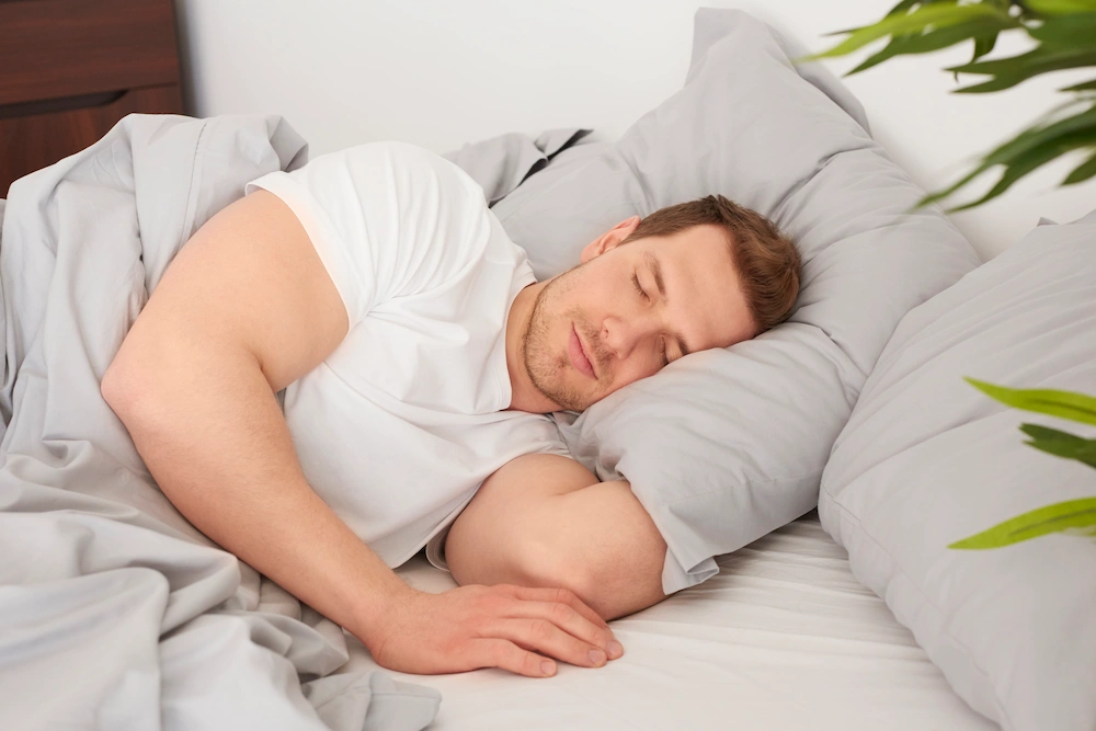Person sleeping on their side with neck or back discomfort