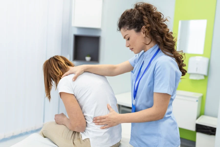 Chiropractor providing treatment for spinal stenosis to relieve nerve pressure and improve mobility
