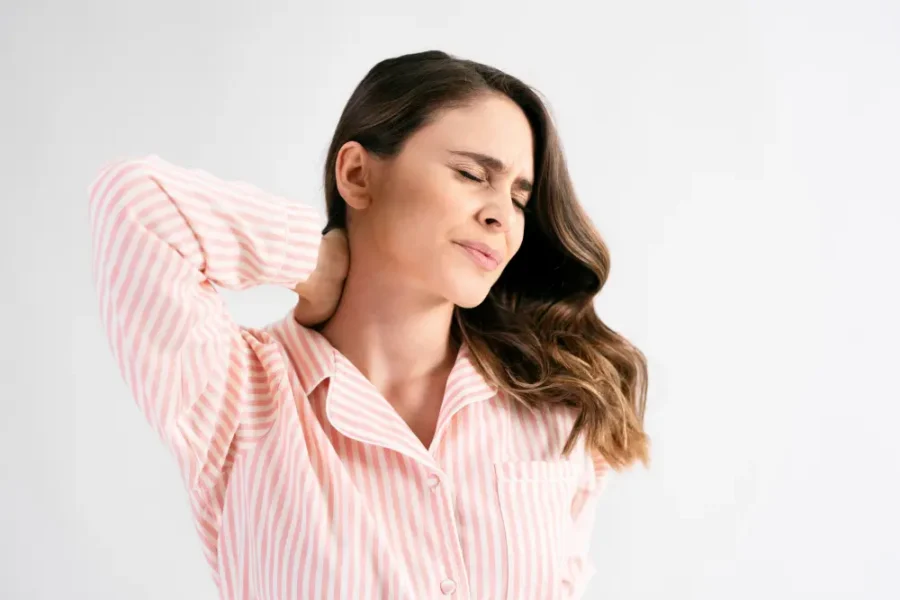 Woman experiencing neck pain and stiffness